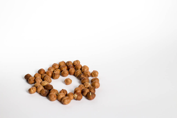 handful of nuts on a white background, almonds and hazelnuts - Foto, Imagem