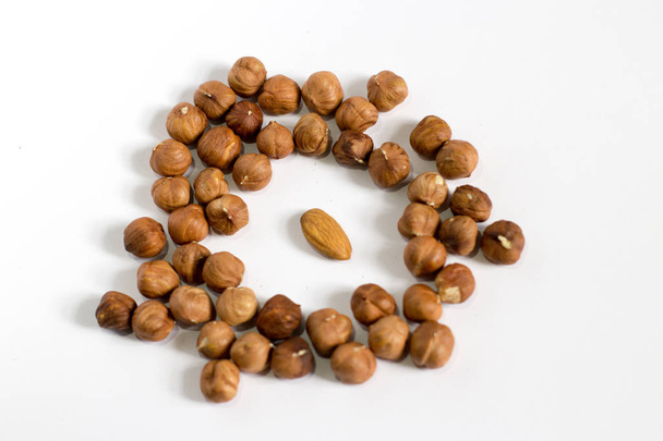 handful of nuts on a white background, almonds and hazelnuts - Фото, зображення