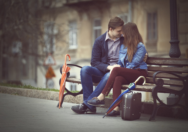 Young couple kissing on the street - 写真・画像