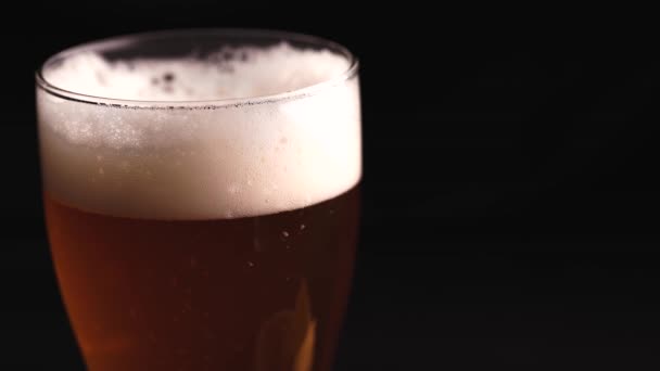Szklanka piwa na czarnym tle - Materiał filmowy, wideo
