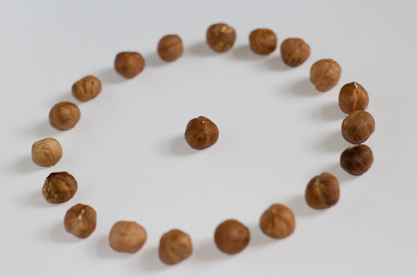 handful of nuts on a white background, almonds and hazelnuts - Zdjęcie, obraz