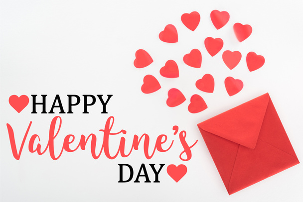elevated view of heart symbols and red envelope isolated on white, happy valentines day - Valokuva, kuva