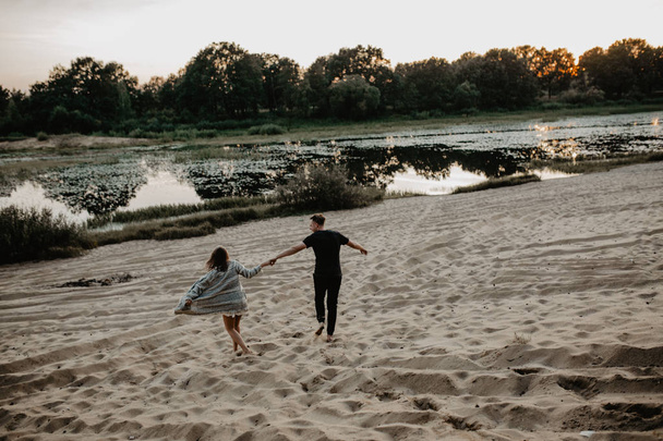 Young couple walking  on the beach  - Valokuva, kuva