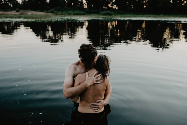 Young couple hugging  in the lake - Фото, зображення