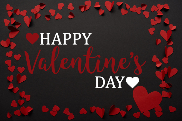 black background with "Happy valentines day" lettering and paper cut red hearts  - Foto, Bild