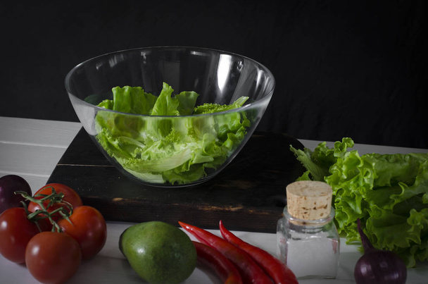 Man is preparing green salad of romaine lettuce. Healthy food concept - Photo, Image
