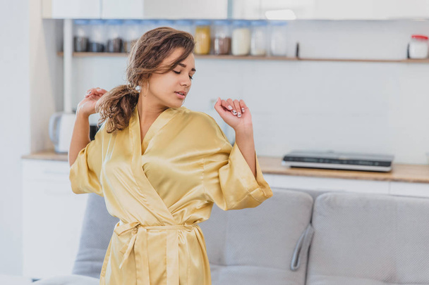 Beautiful girl in bathrobe relaxing at home.Young Woman In Her Morning Routine, After A Shower.Beautiful girl in bathrobe relaxing at home - Фото, зображення