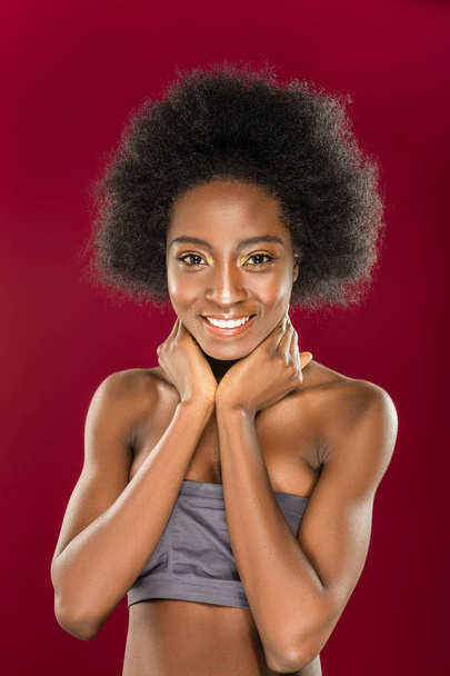 Pleasant afro American woman holding her neck - Foto, Imagem