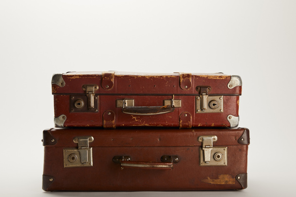 vintage brown suitcases on grey background with copy space  - Zdjęcie, obraz
