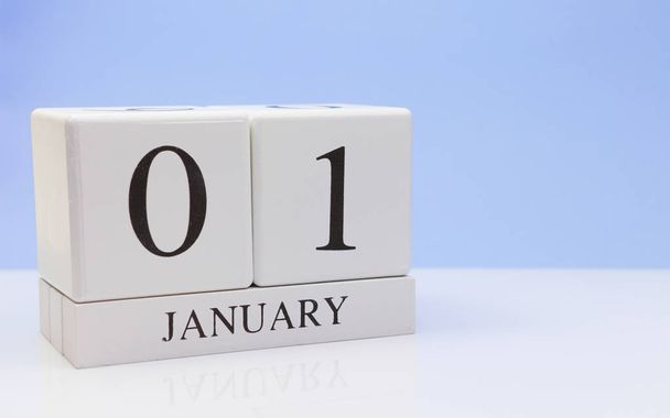 January 01st. Day 01 of month, daily calendar on white table with reflection, with light blue background. Winter time, empty space for text - Φωτογραφία, εικόνα