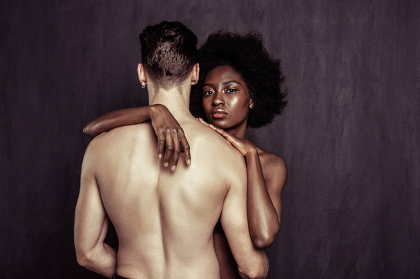 Serious Afro American woman standing behind her boyfriend - Photo, Image