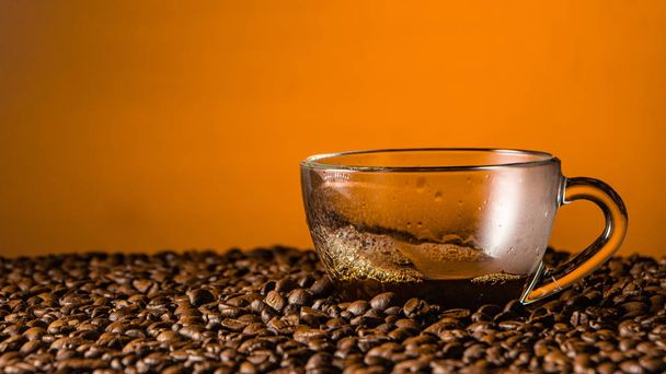 Pouring coffee into cup with splashing on brown background. close up - Photo, Image