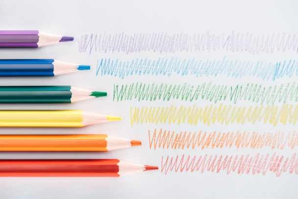 vista superior do arco-íris lápis multicoloridos e traços coloridos no fundo cinza, conceito lgbt
 - Foto, Imagem