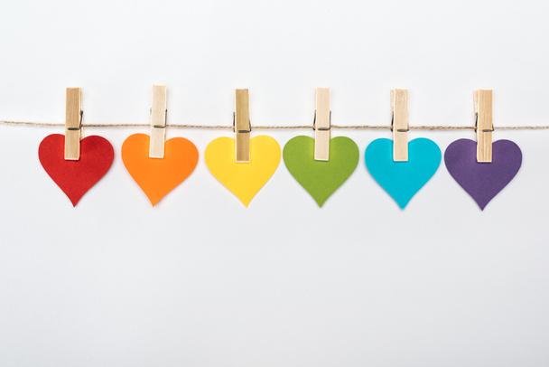 rainbow multicolored paper hearts on rope isolated on white, lgbt concept - Fotoğraf, Görsel