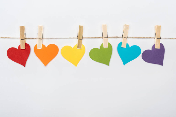 rainbow multicolored paper hearts on rope isolated on white, lgbt concept - Photo, Image