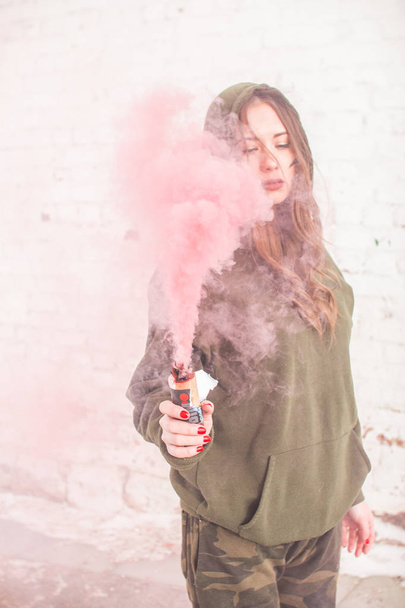 portrait of military girl outdoor of red smoke - Foto, Imagem