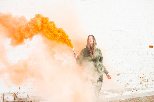 portrait of military girl outdoor of orange smoke - Φωτογραφία, εικόνα