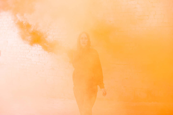 portrait of military girl outdoor of orange smoke - Zdjęcie, obraz