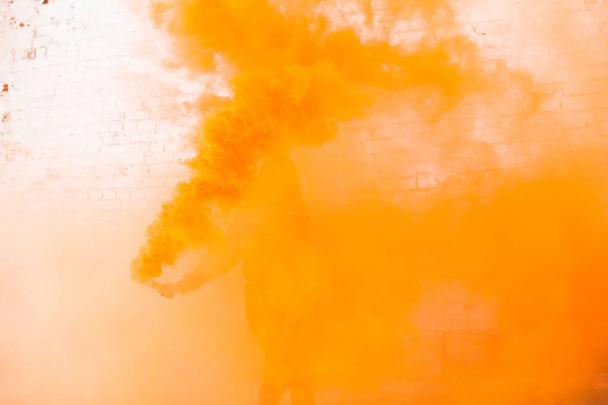 portrait of military girl outdoor of orange smoke - Zdjęcie, obraz