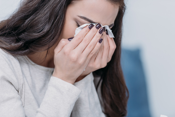 selective focus of grieving woman covering face with hands and crying at home - Photo, Image