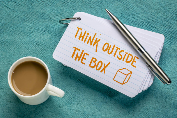 think outside the box - handwriting on a stack of index cards with a cup of coffee and a pen - Photo, image