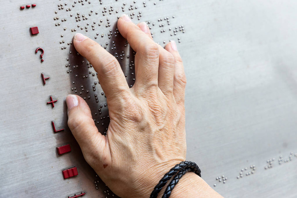 Finger reading braille tactile on public park message board in Hong Kong - Photo, Image