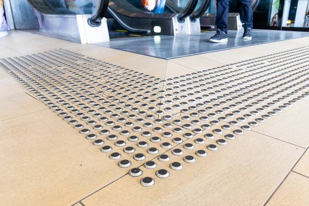 Metal floor tactile to guide vision impaired person at shopping mall in Hong Kong - Photo, Image