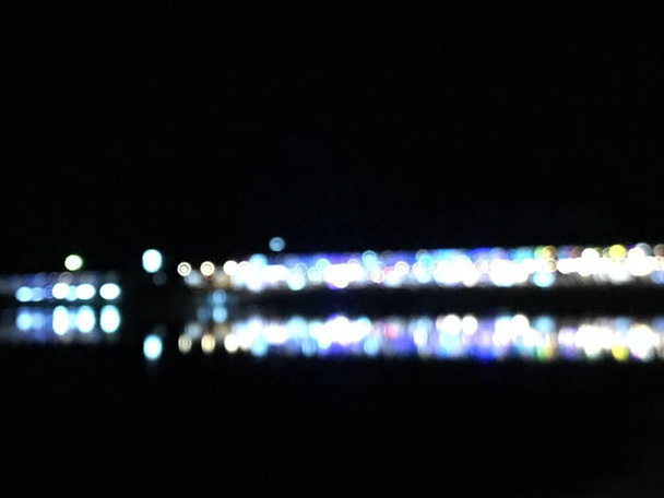 fotografia bokeh offuscata di edifici commerciali quando accendono le luci durante la notte con la sua ombra blu si riflette sulla superficie del lago, utilizzando come sfondo
 - Foto, immagini