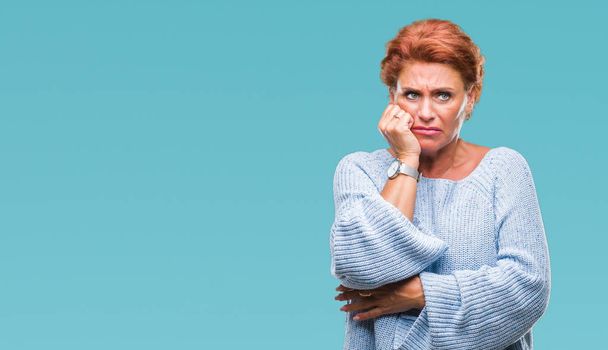 Atrractive senior caucasian redhead woman wearing winter sweater over isolated background looking stressed and nervous with hands on mouth biting nails. Anxiety problem. - Foto, imagen