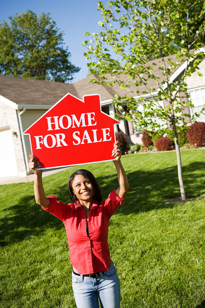 Home: Woman Holds Up For Sale Sign - 写真・画像