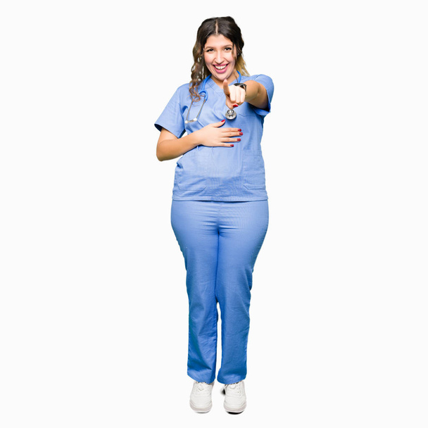 Young adult doctor woman wearing medical uniform Laughing of you, pointing to the camera with finger hand over chest, shame expression - Фото, зображення