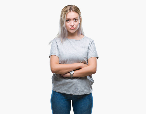 Young blonde woman over isolated background with serious expression on face. Simple and natural looking at the camera. - Photo, Image