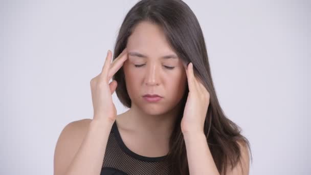 Young stressed multi-ethnic woman having headache ready for gym - Materiaali, video