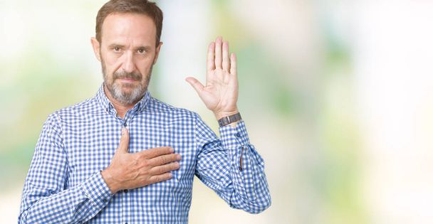 Handsome middle age elegant senior man over isolated background Swearing with hand on chest and open palm, making a loyalty promise oath - Photo, Image