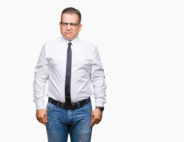 Middle age bussines arab man wearing glasses over isolated background skeptic and nervous, frowning upset because of problem. Negative person. - Фото, зображення