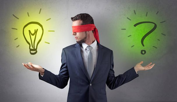 Businessman with idea versus question concept - Photo, Image