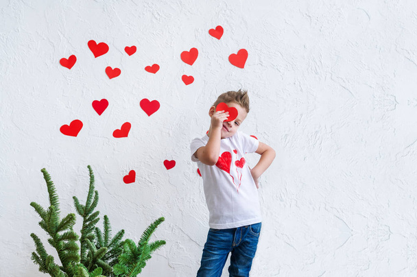 Portrait of a boy with hearts on face. Valentine's Day concept copy space. - Photo, Image