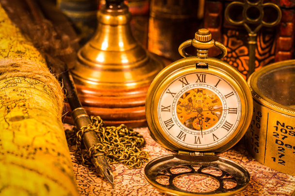 Vintage pen, key and pocket watch. Map of the Ancient World in 1565. - 写真・画像