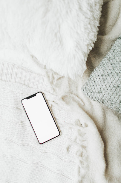 Cell phone mockup with copy space screen on white blanket. Social media, blog, website concept. - Foto, immagini