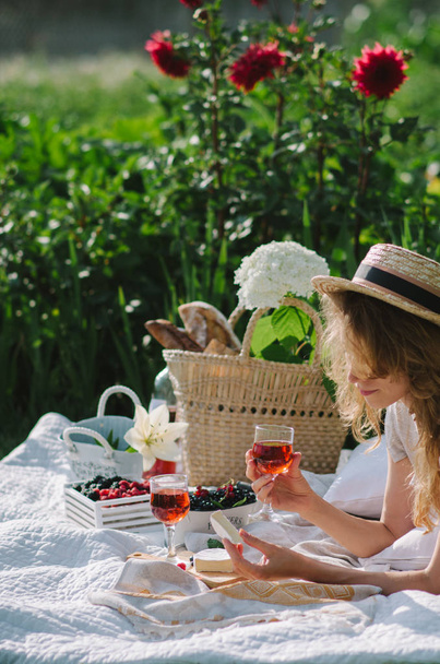 women in a straw hat on a picnic outdoors - 写真・画像