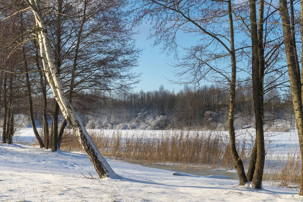 Frozen snow covered river in a winter landscape. Cold frosty winter day weather and seasons concept - Valokuva, kuva