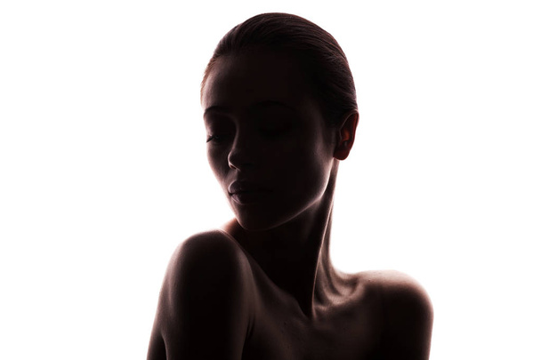 silhouette of young adult woman with clean fresh skin - 写真・画像