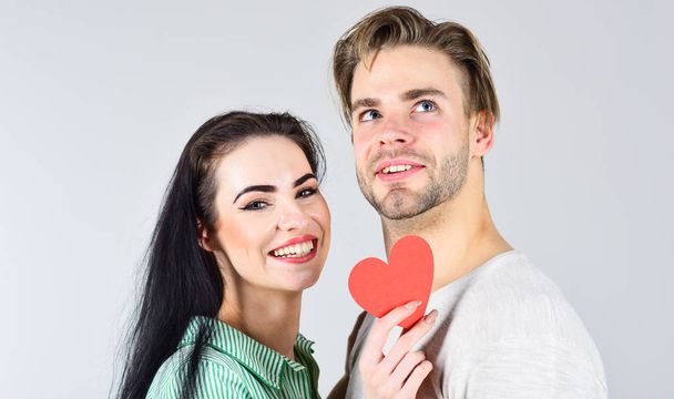 Man and girl in love. Romantic ideas celebrate valentines day. Happy together. Man and woman couple in love hold red paper heart valentines cards. Valentines day and love. Valentines day concept - Foto, Imagen