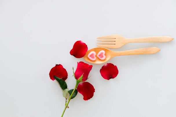 Two jelly shape heart on wood spoon and rose isolated on white background - Foto, Imagem