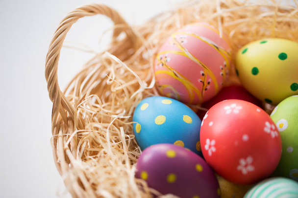 close up of colored easter eggs in basket - Zdjęcie, obraz