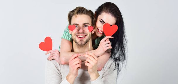 Romantic ideas celebrate valentines day. Man and pretty girl in love. Valentines day and love. Man and woman couple in love hug and hold red heart valentines cards close up. Valentines day concept - Foto, afbeelding