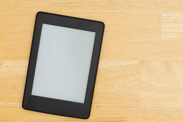 A blank e-reader on a desk that you can use as a mock up for your message - Photo, Image