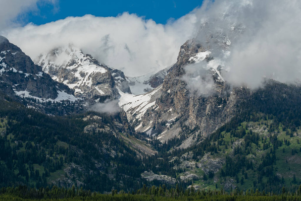Nubes Billow Alrededor de Picos en Teton Range en Wyoming
 - Foto, imagen