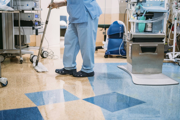 Concept photo of A hospital worker doing cleaning in operation room - Photo, Image