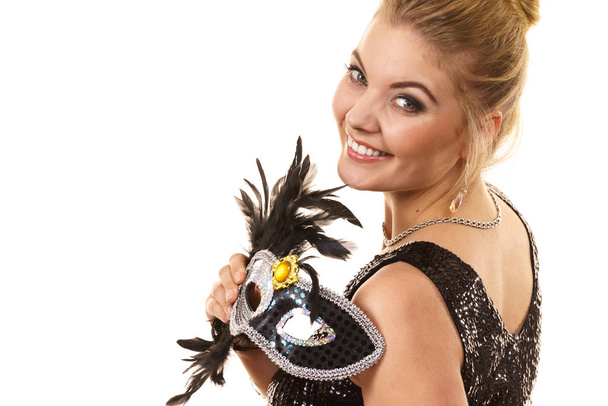 Pretty mysterious woman wearing black carnival mask with feathers. Female being ready for party. - Foto, Bild